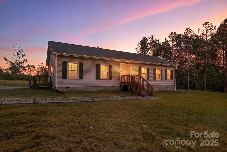 Located off a peaceful, publicly maintained gravel road in the rural countryside of Olin, this modern farmhouse-style 3BD/2BA modular home, built in 2023, offers bright and airy living with 9-foot ceilings and plenty of natural light throughout. The luxuriously sized primary suite features a spa-like bathroom with a large walk-in shower and sit-in tub, providing a serene retreat. The open kitchen includes all appliances and a spacious walk-in pantry, perfect for meal prep and storage. Additional storage needs are met with a convenient outbuilding that stays with the property. This home blends rural tranquility with modern comforts, offering privacy and charm. A rare find in Olin’s scenic countryside.