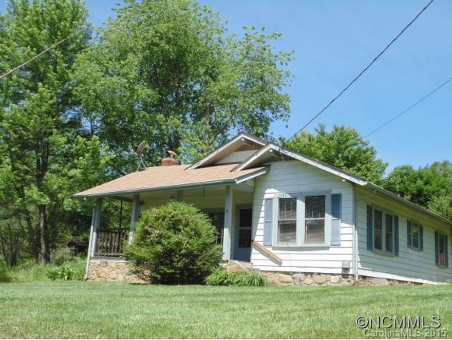West Buncombe: 2 bedroom, 1 bath Farmhouse with useable 2.29 ac. (MOL) level to rolling corner lot, bordered with a stream and mature landscaping. Newer 2 car garage, new roof in 2014, Outbuilding, No restrictions. Approx 15 minutes to I-40.