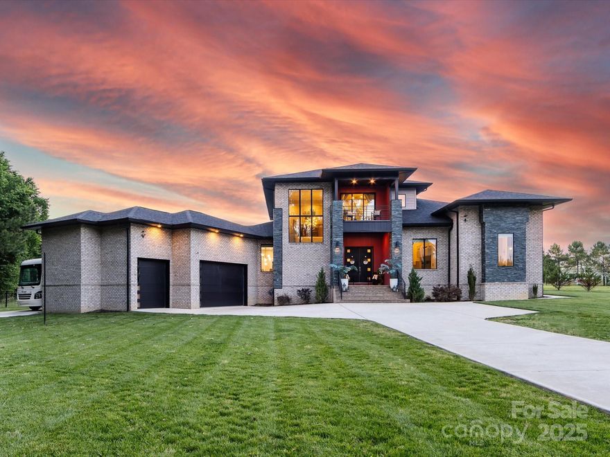 Modern luxury & resort-style living await at this stunning, fully upgraded home in Indian Trail. Priced BELOW appraised value! Light-filled and spacious, this home features sleek architectural design, updated designer lighting & a gourmet kitchen with premium finishes & an oversized island, perfect for entertaining. The open floor plan offers flexibility & function with high ceilings & stylish details throughout. Exit outside to your private backyard retreat with a travertine-surround pool, an outdoor kitchen & a dedicated exercise area, ideal for both relaxation & active living. Every detail has been thoughtfully designed to blend comfort, beauty & convenience. This home offers the best of modern design & outdoor living in one exceptional package. This one-of-a-kind property is a rare find in Indian Trail, modern design & unmatched outdoor living come together beautifully.