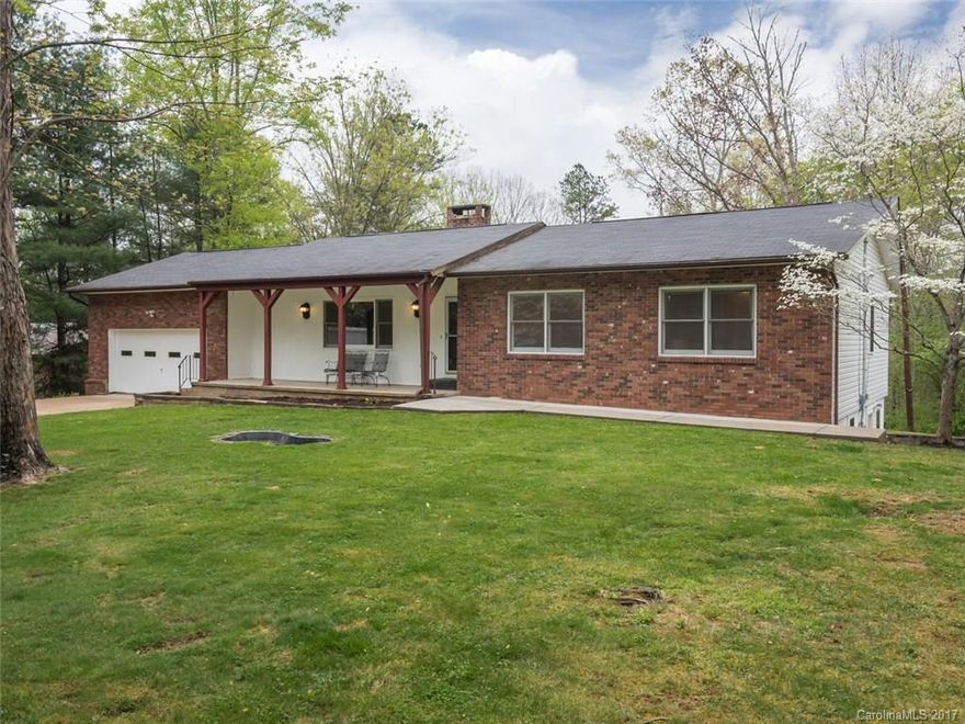Privacy, views, room for all, and nearly 2 acres close to Asheville!  Spacious house on a nearly level lot offers room to expand or subdivide.  Enjoy the completely new kitchen, laminate wood floors, & French doors to the screened back deck.  Cozy wood FP in the living room, heat pump, and backup wood furnace. 1,244 finished sf in the bsmt (completed w/o permit) is plumbed for an additional full bathroom.  3 bd septic permit, w/2 additional tail lines. Oversized 2-car garage has workshop space.