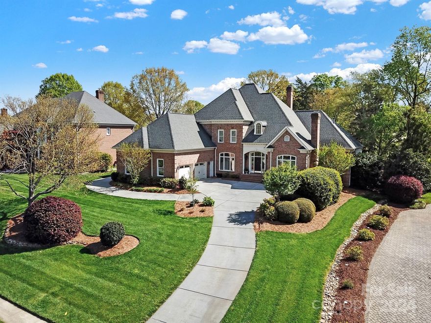 This magnificent transitional home boasts not only luxurious living spaces but also an abundance of storage, totaling close to 900 square feet. From the grand two-story foyer with its impressive staircase to the meticulously crafted crown molding throughout, every detail of this home exudes elegance & functionality. The updated chef's kitchen, featuring stainless steel appliances & a spacious island with a breakfast bar, seamlessly flows into the sun-filled breakfast area & sunroom. The living room, complete with a real log fireplace and built-ins, opens to a covered porch & brick terrace, perfect for outdoor gatherings. The first-floor master suite boasts a spacious bedroom & a luxurious master bathroom with a large Jacuzzi tub. Upstairs, a generous bonus room with a balcony provides stunning views of the golf course. Ample secondary bedrooms ensure comfort for guest. Additionally, the three-car garage offers ample space for vehicles & storage, including golf cart parking.