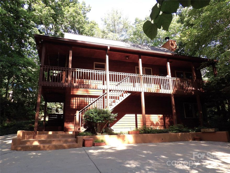 Enjoy the Mountain and Lake Life!  Ready to move in furnished Custom built Cedar Home located in the heart of deisirable Lake Lure!   Fishing, Hiking, Swiming, Kayaking, Paddleboarding, Boating or just enjoy sitting on your private deck among nature and the mature trees or at the fire pit.  The cabin contains a beautiful rock wood burning fireplace, vaulted ceilings and wooded views from every window. Great primary, second home, or vacation rental.  Ideal location puts you within 5 minutes of Lake Lure Beaches, Chimney Rock Park Entrance, Boat Docks, Flowering Bridge, restaurants and shopping.  You will also have interest (1 of 12 owners) to lake front property and access directly accross street where you can launch kayaks that come with this home, or perhaps you want to sit and enjoy the serenity and view of the lake.  Spacious workshop and more room in the basement would allow to add a playroom, gym or guest suite. No HOA's