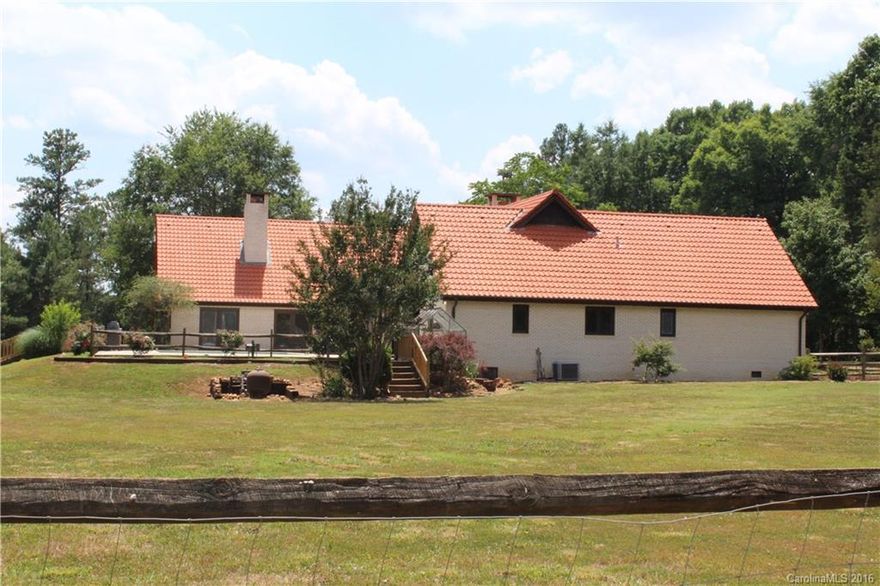 More Picture to come!! Home is in the last stages of a total remodel.  This is a beautiful 21 ac Private Country Estate. The home is built with a Tuscan/European flair.   Home offers 3 beautiful stone fireplaces,  Large rooms,  Tile roof, from Germany, on  both living quarters, panoramic view of the property . Greenhouse, separate mother in law house or office, awesome barn. separate fenced pastures,  and a pool for relaxing.  Estate comes complete with 2 wells, and Fruit Trees. Mins from I 77.