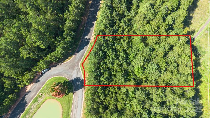 Beautiful, wooded, 0.77 acre lot on a cul-de-sac in the gated, waterfront community of Reflection Pointe on Lake Wylie in Belmont. Tons of amenities including a community clubhouse with in-ground outdoor swimming pool, a recreation area with a playground, two lighted tennis courts, pickle ball courts, a putting green, communal beach area on the lake, waterfront pavilion, ponds with fountains, and several miles of paved walking trails. The neighborhood has a community RV and boat storage area, beach with gazebo and does offer deeded boat slips for purchase through the association. 10 minutes from Downtown Belmont with lots of restaurants & shopping, and approximately 30 minutes from Uptown Charlotte. All building plans must be approved through the architectural review committee. Minimum build is 2,000 sq ft for 1 story homes and 2,400 sq ft for 2-story homes. This lot is ideally suited for a basement. Come build your custom dream home!