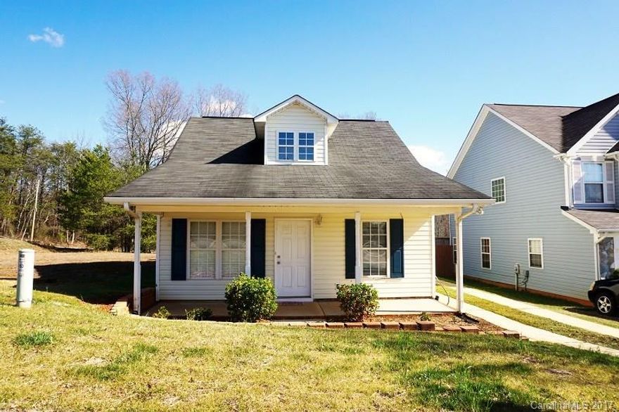 Enter sunny living room w/laminate wood style floors throughout main living area & kitchen. Kitchen features white cabinets, refrigerator. The eat-in area offers glass doors leading out onto the patio. 2 BR on the main level & full bath. Upstairs host what looks to be the master bedroom (but there is no door). Master features new carpet, walk-in closet, private bath & extra space. The upstairs are currently being used as MBR could also be a bonus room. Security system, sidewalks, gas heat.
