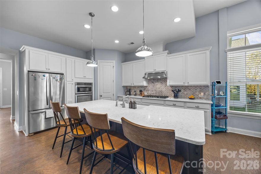 This luxurious John Weiland home in desirable Habersham offers the features and spaces today's buyers desire! The welcoming covered front porch, covered back porch, and stone paver patio offer lots of outdoor spaces for relaxing and entertaining. Wide entry hall with study off to the left, then opening into the main living area where kitchen, dining, and greatroom create an open and inviting space for gatherings. 10+'  ceilings, 8' doors, and 5" wood floors on the main level. The gourmet kitchen features a huge island, quartz countertops, tile backsplash, gas cooktop, wall oven, farmhouse sink, WI pantry w wood shelving. Laundry room with mud area/drop zone. Great room features a stone fireplace w gas logs and built-in storage on either side. High ceilings and loads of windows let in lots of natural light. The spacious primary suite offers 2 WI closets, seamless glass shower, soaking tub, custom tile, beautiful vanity top! Upstairs you'll find a large loft/flex space offering a multitude of uses. 2 of the bedrooms are connected by Jack n Jill bath with private sink areas for each room. 4th bedroom is extra large w ensuite bath. . All of this...PLUS awesome Habersham amenities, great Fort Mill schools, and close proximity to shopping/interstate/downtown Fort Mill come together to create a wonderful place to live!