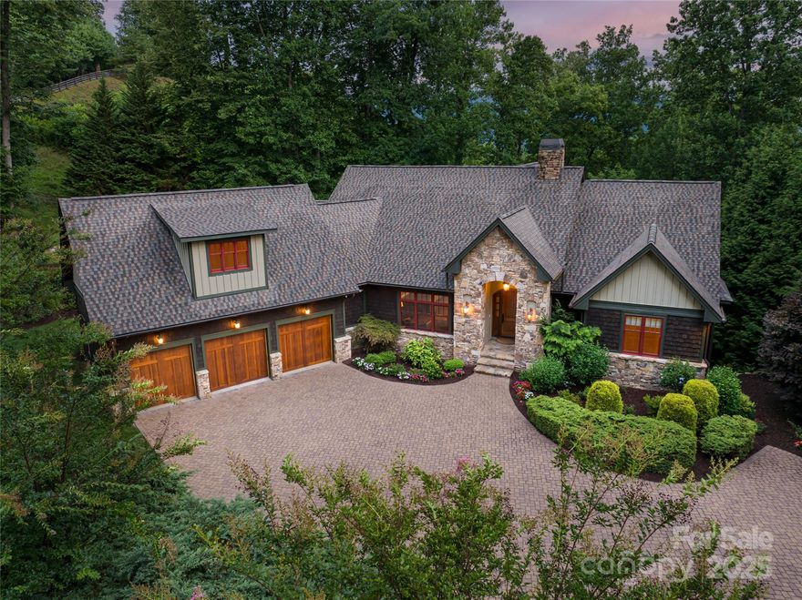 Perched above the storied greens of the Waynesville Inn & Golf & just 5 minutes from downtown, this award-winning mountain craftsman offers the best in function and form. A Parade of Homes winner on a rare double lot, it features wooded privacy, year-round views, & space for your future vision. Inside, find 2 spacious primary suites and 2 guest suites, open living with hardwood floors, & 2 stone fireplaces. The chef’s kitchen includes Thermador appliances, custom cabinetry, & large island with rare mesquite wood countertop to balance the surrounding granite. Downstairs, enjoy a home cinema, full bar with wine tower, guest suites & flexible family room. Outdoor living shines with summer kitchen with fireplace, firepit patio, & two stately covered decks. Oversized 3-car garage on main adds convenience. Control4 automation, surround sound, heated bath floors, & ample upgrades abound. Located in a peaceful setting just minutes to area attractions this is mountain living without compromise.