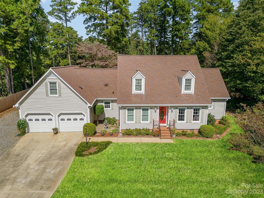 HUGE PRICE IMPROVEMENT and FRESH COSMETIC UPDATES on this beautifully custom crafted 3-bedroom, 2.5-bathroom Cape Cod home situated on the prestigious Westport Golf Course. Nestled on the 13th tee box with views of the 12th green in a LAKE FRONT community. The property has been meticulously maintained inside and out and offers many custom features such as white oak floors, granite on all counters, solid wood kitchen cabinets and solid interior doors. The primary suite on the main level is a tranquil oasis with an en-suite bathroom and oversized closet space. Wake up to the beauty of your own private deck with a view of  flowers, trees, and plants.  Each additional bedroom on the upper level boasts its own walk-in closet. The substantial bonus room provides versatile living space with convenient walk-in attic storage space. The Westport Club offers golf, swim and tennis with full membership or al a carte memberships. Located .5 miles from Lake Norman and 20 miles from Charlotte.
