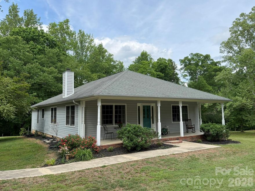 Discover the ultimate nearly 21 acre equestrian retreat, meticulously crafted and maintained since 2000. The current owners purchased this charming home, and then built the barn, installed culverts over the two meandering creeks to access the rear property, and cleared and fenced 2 pastures. The barn features 3 stalls,  grooming stall, and tack room (all 12’x15’) and a center isle with the lowest point at 8.5’. Tack room has storage shelves and hanging racks that remain if desired. At the rear are stairs to the upstairs storage/loft. Behind the barn is a storage building with 220 wiring for the kiln that remains, where the owner- artist fired the pottery made from clay harvested from the creeks on the property. (Note there is no flood plain according to the GIS). Sellers also added the huge 36’x30’ triple garage with separate meter, a 220 RV hookup, 9’ tall by 10’ wide doors, and soaring ceiling height (about 13.5’-17’) for ample room for large projects or even a vehicle lift. To protect tractors and trailers from the elements, there’s also a 3 bay equipment shed for tractors or trailers. To add to the outdoor life, there’s a firepit behind the garage. All of this, plus a lovely home with a wide rocking chair front porch to relax after coming back from a trail ride. Step through the front door to the great room with combined living, dining, and kitchen with pine floors, wood stove for cozy winter evenings, and kitchen with breakfast bar, granite counter tops, and tiled backsplash. (Refrigerator and washer dryer can remain).  Primary bedroom has private bath with whirlpool tub, a step in shower new in 2025, and new flooring April 2026.  House has been freshly painted inside, and is move-in ready for you to begin living your horse lover’s dream.