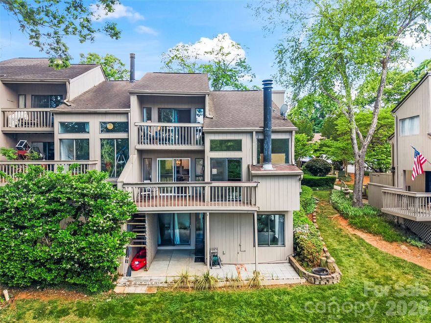 Experience refined lakefront living in this beautifully maintained 4-bedroom, 3-bath end-unit condo located in the sought-after Bluff Villas within River Hills. Perfectly positioned to take advantage of stunning water and marina views, this home offers a peaceful retreat with a layout designed for both comfort and style.

Step inside to an inviting foyer that opens into a light-filled living space with two-story great room, expansive windows, and a striking stone-accented gas fireplace. The kitchen is both stylish and functional, featuring granite countertops, white cabinetry, a herringbone tile backsplash, stainless steel appliances, and a pantry for added storage. The open-concept design flows seamlessly into the dining and living areas, making it ideal for entertaining.

An upper-level loft with built-in shelving and a dedicated workspace overlooks the great room below, adding flexibility for a home office or reading nook. The primary suite is a true retreat, complete with vaulted ceilings, a walk-in closet, dual vanities, and a private balcony where you can take in tranquil lake views.

With a bedroom and full bath on each level, this home offers versatility for guests or multi-generational living. The lower level features a spacious recreation room with walk-out access to a patio that leads toward the water, perfect for relaxing or enjoying the outdoors.

Located within the gated River Hills community, residents enjoy a serene, nature-filled environment with convenient access to local amenities. This is a rare opportunity to enjoy low-maintenance living with beautiful lake views in one of the area’s most desirable communities.