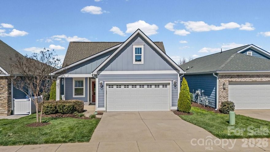 Open-concept Glory plan on an exceptional lot with long range views. Split 2BR, 2B open concept plan features a customizable multiuse flex space. The well-appointed kitchen anchors the main living area and includes SS appliances, gas range, farm sink, solid surface countertops, pendant lighting, light craftsman style cabinetry w/soft close drawers, tile back splash and island serving bar. Adjoining great room is highlighted with a gas log fireplace and wall of glass that opens to a peaceful screened lanai and well landscaped fenced rear yard that extends in and outdoor entertaining options.  A serene master suite completes this home & ensuite bath with dual sink vanity, tile floor and a generous walk-in closet & tiled shower with grab bars for safety. Plantation shutters, low maintenance wood and tile flooring (no carpet) and a large laundry room with additional counter space and cabinet. Attached 2 Car garage for additional storage options for all those things you just couldn't part with. Trilogy Membership includes Freedom Boat Club on Lake Norman plus award winning amenities