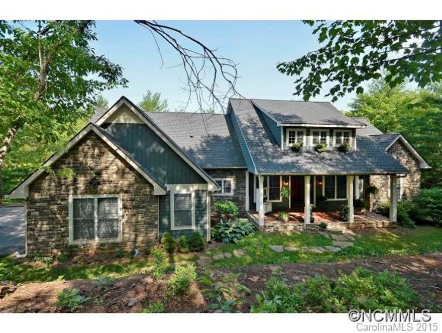 One of a kind English Country Cottage. Delightful covered front porch with southern Living styles sets off this custom built home. Enter through beautiful arched doors into a truly amazing open floor plan with cherry wood floors, stacked stone fireplace and a kitchen made for entertaining. The functional split bedroom plan allows for a private master suite. The finished, walkout lower level has ample space for an office/studio and a workshop