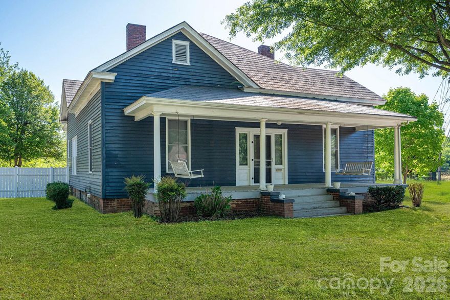 This gorgeous 1924 home has been lovingly owned by the same family for more than 100 years and is filled with timeless character and charm. From the expansive hallway with picture-frame crown molding to the original hardwood floors, this home offers a glimpse into classic craftsmanship. Enjoy relaxing on the rocking-chair front porch and the convenience of an in-town location. The property also features a detached carport with additional shed space, a deck off the back, and a fenced-in backyard. With generous living space throughout, this home offers endless potential for those looking to restore, update, or simply appreciate its historic beauty. There are 4 fireplaces that are covered. The security camera does not convey. Home back on the market no fault of seller.  The second buyer had a change of heart after a week, no inspections completed. First buyer had inspection and RPOADS has been updated to reflect items found in the inspection. The first buyer terminated after we were one minute late responding about repairs.