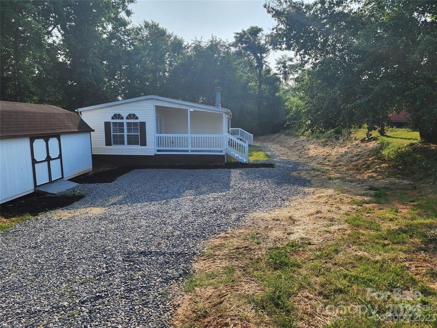 Welcome to this captivating 3 bedroom, 2 bath home that effortlessly combines style and functionality. Step into an oasis of fresh paint, creating a bright and inviting atmosphere throughout. Discover a spacious kitchen adorned with ample cabinets, offering abundant storage for all your culinary needs. Experience the perfect harmony of an open concept floor plan, allowing you to relax by the cozy wood burning fireplace while enjoying the company of loved ones. Relish in the luxury of a formal dining room, ideal for hosting elegant gatherings, as well as a charming breakfast nook for casual meals. Indulge in blissful relaxation with a large soaking tub in the master bedroom, creating a tranquil haven within your own retreat. Appreciate the outdoor serenity on the covered deck on the side of the home, providing a peaceful escape for outdoor relaxation. Additionally, the driveway has been recently graded and received new rock, ensuring easy accessibility