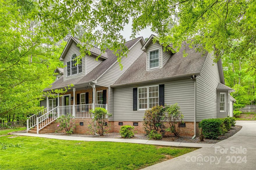 This peaceful home is on a 1 acre lot with a large front yard and peaceful front porch. The home has fresh neutral paint throughout and new carpet and flooring. The main level has hardwood floors, with a living room with fireplace open to the large kitchen with island and breakfast area with updated lighting and fans. The main level has 3 bedrooms and 2 full baths. The primary bedroom has tray ceilings with updated bath and walk in closets. The second level has a large loft and bonus room with full bathroom. There is also a large unfinished walkout storage space off of the loft. Septic permit is for 3 bedrooms but upstairs has been used as a bedroom. Fresh deck boards off of the screened porch lead to the large heated and cooled 3 car garage shop complete with high ceilings, office, and half bath. A dream for anyone looking for a large work space! Convenient to shopping and restaurants. Move right in to your new retreat! Virtual Tour: https://my.matterport.com/show/?m=yRpsX6jpyWg