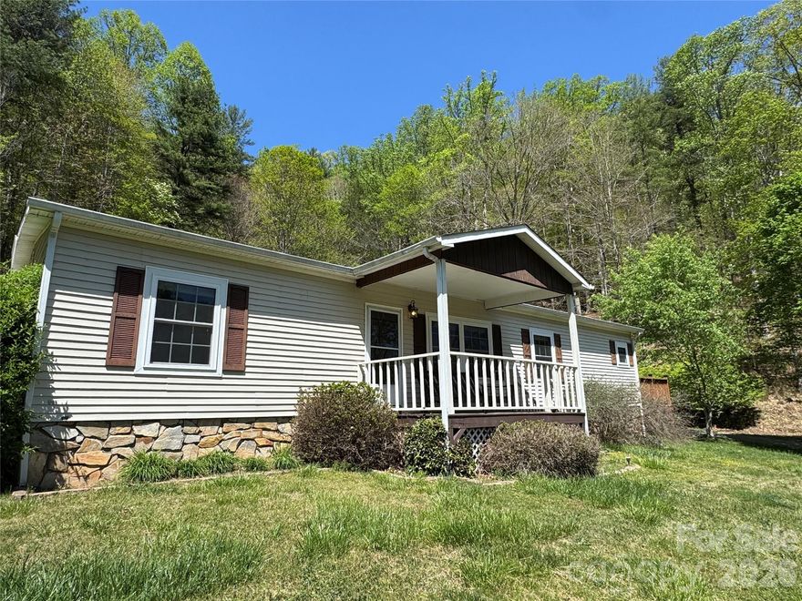 Tucked away on 4.7 private acres in sought-after Madison County, this inviting 3-bedroom, 2-bath home offers the perfect blend of comfort, space, and mountain lifestyle. Featuring hardwood floors and an open floor plan, the home is designed for easy living and entertaining. Enjoy ample outdoor space for gardening, relaxing, and gathering with family and friends. Explore hiking trails right on your own property, offering a true connection to nature. Two storage sheds plus a powered workshop with a wood-burning stove provide endless possibilities for hobbies, storage, or projects. Private yet conveniently located near both Marshall and Mars Hill, this property offers peaceful mountain living with easy access to town amenities. An opportunity to own acreage, privacy, and versatility in beautiful Madison County.