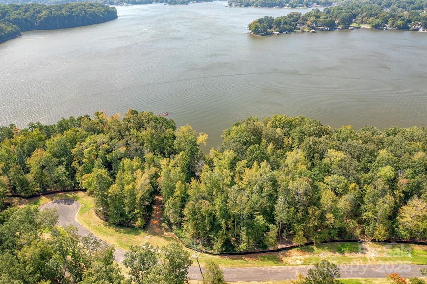 Premier waterfront community on Lake Wylie in Belmont NC. Homesite 21 is in the state of South Carolina on Great Egret. The homesite would accommodate a basement or crawl foundation and features long southern main channel views, plus you capture the eastern and western sun on the sides. Located on a cul-de-sac street so you have less traffic. Homesite 21 can accommodate a boat dock with your permit from Duke Lake Management at the time you build your home. This location does not offer dredging from Duke Lake Management. McLean features exceptional approved builders who can bring your desired home design to life on this beautiful homesite. Once you purchase the homesite, there is no time limit in which you are required to start building a home, so the timing is flexible to your needs! McLean is located in an amazing spot that is quiet, yet so close to so much! Love small town living and casual downtown vibe when you visit the quaint town of Belmont NC - only about a 10-minute drive from McLean. Enjoy Stowe Park in the center of Belmont, or  coffee at Everyday Market, watch the train go by, play/jog/lounge at the park while listening to the fountain on sunny days, or meet friends for dinner at any of the great restaurants in town. Take in all that Uptown Charlotte has to offer in restaurants, theater, sports, and other events - just 30 minutes away. Travel far and wide for work or play - the Charlotte Douglas international airport is only 20 minutes away and you don't even have to get on the highway - YAY! Premier waterfront living is featured at McLean South Shore, the preeminent community within McLean. McLean South Shore offers walking trails, clubhouse, outdoor pool, fitness center, playground. Drift restaurant within walking or golf cart distance. The Carolina Thread trail along Lake Wylie located across New Hope Road. Within minutes of grocery shopping - Publix and Harris Teeter. Uptown Charlotte, South Park and Ballantyne are commutable via nearby highways. Great small town location at the doorstep of a bigger city! Premier waterfront community - Let's walk this homesite today!