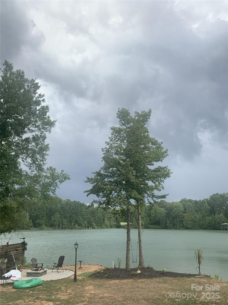 Waterfront lot on 5 acres offers peaceful country living with privacy and endless possibilities. This well-maintained newer home features a cozy living room with a fireplace and built-in bookcases. The kitchen and dining area include an island with bar seating, ample workspace, and a beautiful view of the pond from the back window. A split-bedroom floor plan provides added privacy, making it ideal for families or guests. Enjoy the outdoors and natural surroundings of this private gem in the woods—perfect for those seeking quiet, space, and comfort in a scenic setting.