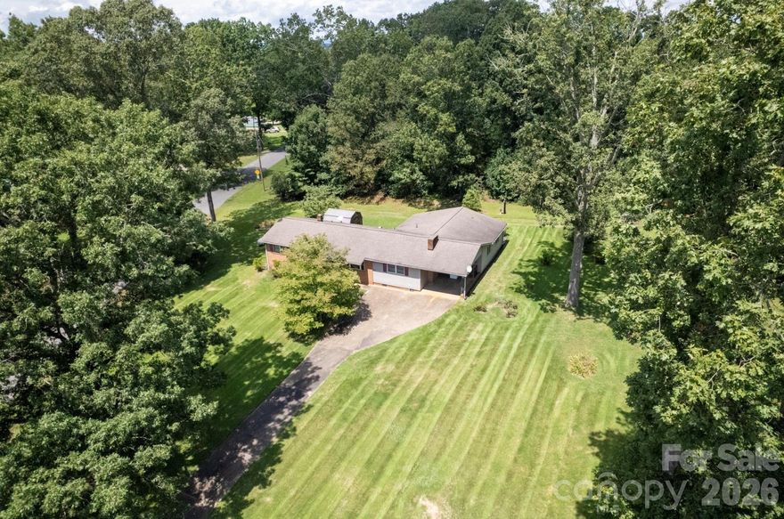 Well-maintained home on a spacious 3.28 acre corner lot in the quiet countryside ready for your personal touch! Great bones, newer windows, and large rooms! Living room, spacious kitchen w/ wood cabinets, tons of counter space, and refrigerator included, den with fireplace, large bonus room, three bedrooms and two baths. Laundry room is inside but is not counted in HLA because it is unfinished. Large primary bedroom with ensuite bath that has an accessible shower for a wheelchair user. Beautiful lawn and field with large barn that has water and electricity. Mature trees along West Zion Church Rd. create privacy and ambiance. Old greenhouse could be revived! Other amenities include a whole house generator, additional storage building, great pantry, and sellers are offering a ONE YEAR HOME WARRANTY for buyers' peace of mind! House has county water, but barn is on well water. Sellers state that there are hardwoods under most floors, but buyers will need to verify. This listing is for 3.28 acres - parcel 30692 which includes the house.  Septic permitted for 3 bedrooms. Schedule your showing today!