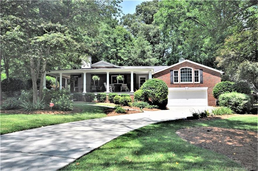 Lovely brick ranch home for one level living with wrap-around porch, hardwood floors, gas log fireplace, real wood paneling, moldings, architectural shelving & fab retro tile in the bathrooms. Updated kitchen with stone floor & back-splash. The stone floor continues into a large laundry/mudroom. Separate bonus room/guest suite with veranda,bath & attic space-plumbed & wired for a kitchenette! Nestled on an over-sized lot with shade trees in beautiful neighborhood!