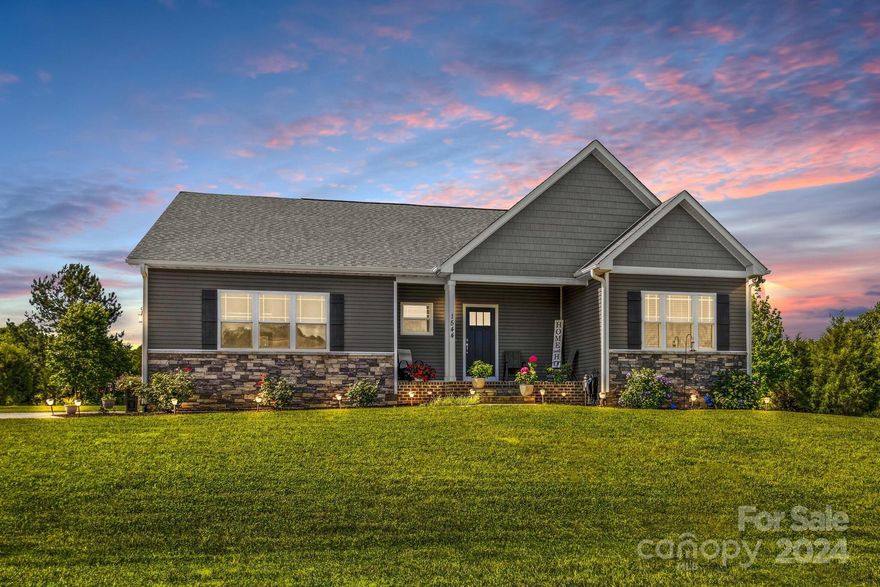 Nestled in a serene country setting yet just minutes from shopping, restaurants & interstate, this charming 3-bedroom, 2-bathroom ranch home in Birtwick Park looks brand new. Situated on .93 acre and spanning over 1,800 square feet, this home features an ideal open floor plan. The combined living room, dining area & kitchen create a perfect space for entertaining. The kitchen is a chef's dream with a large pantry, stainless steel appliances, ample cabinetry, granite countertops & a spacious island. The living room, boasting a cozy fireplace with gas logs, offers a fantastic view of the private backyard. The expansive primary ensuite includes granite countertops, double vanities, a tile shower & a generous walk-in closet. Unwind after a long day on the screened-in porch overlooking the peaceful backyard. Additional amenities include a 2-car garage, tankless water heater & beautiful landscaping.   Don’t miss out on the opportunity to own this stunning home; make your appointment today!