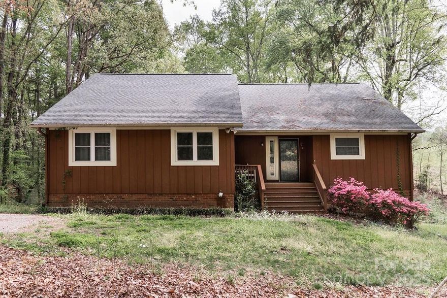 Outstanding large country home! In River Pines with close proximity to Lake Wylie, boat ramps, fishing, camping, etc. Situated on a large 1.2 acre lot adjacent to a large open space easement with privacy and easy country living. 3+ bedrooms and 3 baths. Large open kitchen with breakfast bar looks out over an expansive back and side yard. Work your way toward the back of the home through the dining room, family room and then through the enclosed back porch and onto the large deck overlooking the back yard. Downstairs leads you through several nice sized rooms that could easily be used as additional bedrooms, a full bath and another large family room with a second fireplace. Upstairs there is an unfinished room just waiting to be converted into an office. Contact Steve Reeves and make this your own piece of paradise today!
