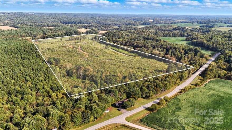 Discover 66+ acres of beautiful North Carolina countryside, ideally suited for your dream homestead or investment. This expansive residentially zoned property offers endless possibilities — from farming and equestrian pursuits to timber harvesting or creating a stunning private estate, or a hunting camp to serve family and friends alike. Towering mature hardwoods, gently rolling terrain which has been partially cleared and a picturesque creek provide a serene natural setting. A portion of the land is used for crops. Enjoy both privacy and convenience with frontage off Harmony Highway. Whether you envision a working farm, recreational retreat, or secluded homesite, this property offers the perfect canvas for your vision. Access to the property is provided via a deeded easement utilizing Barnard Lane. Please note only a small portion of the property fronts Harmony Highway.