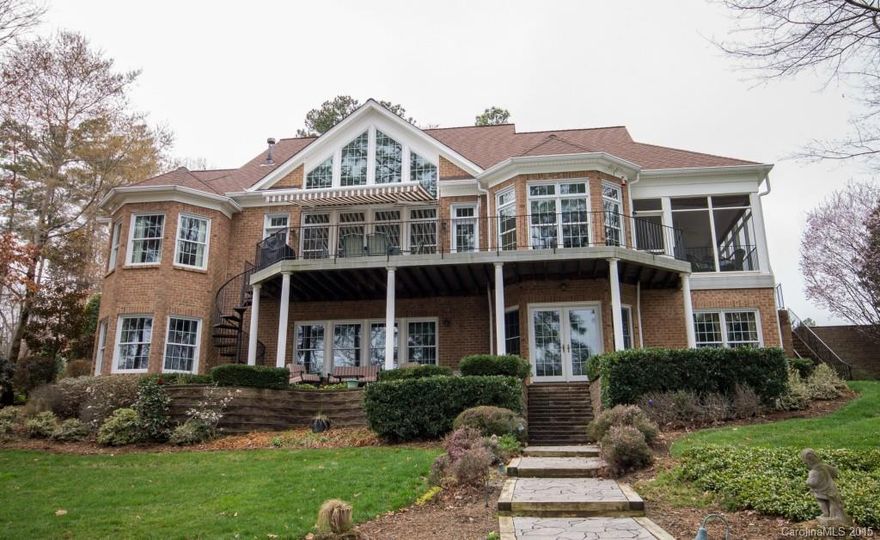 Picturesque Lake Norman WF w/true 2nd Liv Qtrs! Paver walkways lead to WF w/Deep water, Pier w/vinyl decking & Cov Dock w/Slip.  Relax on Screen Porch, (Trex) Deck w/Sunbrella awning or Cov lower patio. Moldings & HW floors accent DR, 2 Sty GR, Office & Master w/built-ins, 2 sided FP, sit area & deck access. Main Kitchen w/butler pantry, granite & eat-in island. Upper BR, Bath & 2 Bonus Rms.  Lower lvl Full Kitchen/Dining, Rec/GR, Media, 2nd Master, Full Bath +Huge heated W/shop & storage.