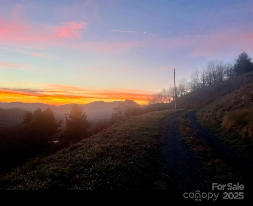 Welcome to 11 Wildflower Lane — a beautiful mountain retreat offering breathtaking, long-range unobstructed views from both the main and lower decks. This spacious 3-bedroom, 3.5-bath home sits on just over an acre in a peaceful setting just minutes from the town of Newland. Step inside to find vaulted ceilings in the living room, an inviting gas-log fireplace, and an open floor plan that would be great for entertaining. The primary suite on the main level features a large en-suite bath and mountain views right from your window. The upper level comprises a comfortable guest bedroom and a loft that can be repurposed as an additional bedroom or home office, complete with a full bathroom. The lower level features a spacious second family room with a fireplace, a bedroom, a full bathroom, a laundry room, and storage space, providing ample space for accommodating guests. In 2025, an unpermitted three-car garage was constructed with living space situated above the garage. Enjoy the scenery from nearly every room in the house, with panoramic mountain vistas that will take your breath away. Whether used as a full-time residence, vacation home, or short-term rental, this property offers the perfect blend of comfort and High Country charm. Seller is offering seller financing with 20% down payment.