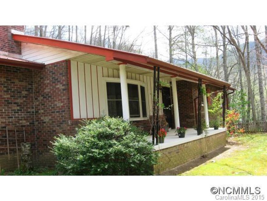 Private, solid, one level living brick home right across the road from native trout stream, hiking from your front door, biking, tubing, beautiful Cane River Valley in WNC. Paved drive and off state maintained road, this gem of a home is priced to sell.  Rocking chair front porch, screens deck off master, 3 beds/2 baths, fireplace, fenced yard, great for pets, garden spot.  Too much to list. Must see.