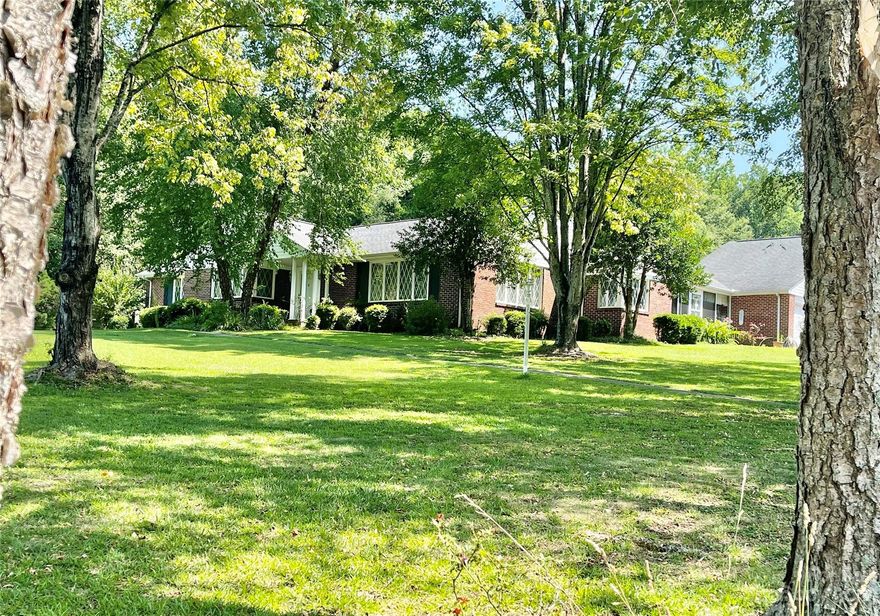 Back on the market at no fault of the seller or home! The prestigious Hillcrest neighborhood has always been one of the most sought after places to live in Great Falls. This stunning Colonial home with European flair has been admired for years by the locals. With over 2500 sq ft of living space on one floor, formal living and dining rooms, beautiful hardwood floors and high end casement windows, you will see why this residence has been a crown jewel of this neighborhood for decades. In addition to fantastic entertainment spaces, you will enjoy the large but cozy family rooms, over sized bedrooms, considerable closets for a home from this era, a walk in pantry, the most charming glass enclosed breezeway and adorable patio area. The kitchen has a basement that could easily be turned into a wine/root cellar. 4 car garage and large corner lot with plush, mature grass and landscaping. Great Falls is conveniently located approx 45 minutes to Charlotte and Columbia, great for commuters!