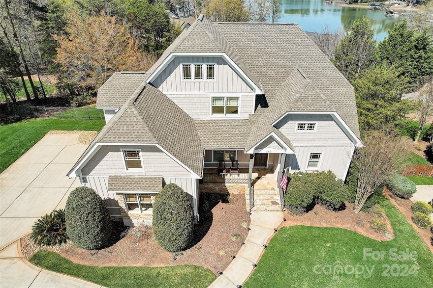 Stunning home in Tuskarora Point with Lake Norman views from both sides of the house, your own BOATSLIP, and a gorgeous fully renovated outdoor entertainment area with inground pool and spa, travertine tile, gas fire pit, covered and heated outdoor kitchen and dining area and a custom firewall. Great room features soaring 2 story ceilings and stacked stone fireplace.  Spacious kitchen with induction cooktop, pot filler, wall oven, large island prep space, breakfast nook, and two pantries. Formal dining room has lighted tray ceiling. Primary bedroom on main level has water views, tray ceiling, and door out to deck. Ensuite bath with jetted tub, tile shower, dual vanities, and spacious walk in closet. Upstairs features three more bedrooms, two full baths and a large bonus room. The walkout basement includes a family room with second gas fireplace, billiards area, kitchenette/bar with sink & refrigerator, dining area, and another spacious bedroom with full bath. NEW ROOF in Nov 2023.