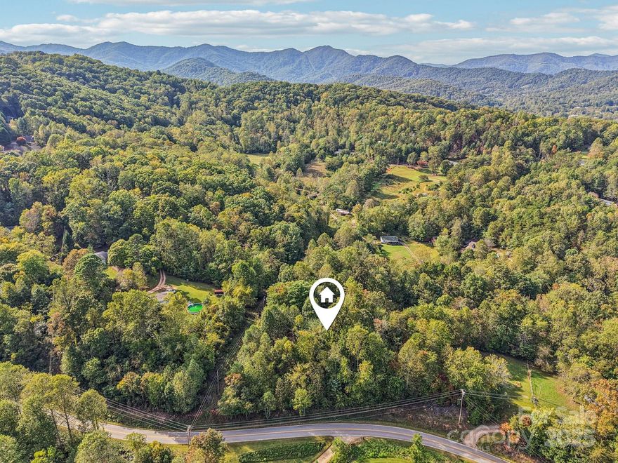 Escape to your own private mountain haven on 6.34 beautiful acres off Upper Glady Fork Road in Candler, North Carolina. This property offers the perfect blend of peace, privacy, and convenience—surrounded by mature hardwoods, gentle slopes, and potential long-range mountain views. Enjoy the serenity of nature while being only 15 minutes from shopping and dining in Candler and West Asheville, and just 15 minutes to the Blue Ridge Parkway.

With a private driveway providing easy access, this land offers multiple potential building sites for your dream home, private retreat, or investment property. The wooded setting creates a tranquil atmosphere for year-round enjoyment, with the sounds of nature and the changing mountain seasons right outside your door. The property’s zoning (Open Use) allows flexibility for residential or recreational use, with no HOA restrictions and no city taxes. A septic system will be needed, and there is an existing well on site, though its functionality is currently unknown.

Whether you’re envisioning a modern mountain estate, a rustic log cabin, or a simple getaway tucked among the trees, this property provides the space and freedom to make it your own. Located on a publicly maintained road between Suddreth Lane and Crowes Nest View, you’ll enjoy both seclusion and accessibility in one of Western North Carolina’s most desirable regions.

This stunning tract offers endless possibilities—build, explore, or simply hold as an investment in the natural beauty of the Blue Ridge Mountains. Experience the best of mountain living with modern convenience just minutes away.