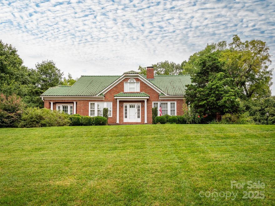 Beautiful all brick home packed with historical charm and carefully blended modern updates. Deep covered side porch with ample shade and room for seating options. And just inside is the living room with a gas log fireplace, flowing seamlessly into the large dining room and sunroom beyond. The beautifully renovated kitchen has soft close cabinetry, quartz countertops, a tile backsplash and a professional grade gas range with double ovens. Adjacent to the kitchen, the breakfast area features some of the original built-in cabinets with classic details. The primary bedroom on the main floor has a flex space which could be used as a den or an office, and the vintage mid-century full bath is a show stopper. One more bedroom on the main level, plus two bedrooms on the upper level. The upstairs bath has been smartly remodeled to include a dual sink vanity with marble counters, built-in storage and a large walk-in tile shower. Original heart of pine and oak flooring beneath the carpeting on both levels, per the sellers. Additional features which give this home its timeless elegance include the abundance of custom woodwork, graceful arches, thoughtful built-ins (including a window seat with storage), interior transom windows and a few vintage light fixtures. The unfinished basement offers additional storage and work space as well. Super durable clay tile roofing. Located in the desirable Hillcrest neighborhood off of South Union Street, very convenient to revitalized Historic Downtown Concord with local restaurants and unique shops to enjoy.