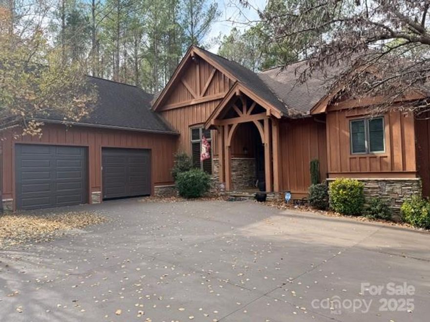 Beautiful Waterfront Home with shared pier access to the water. Large home with main level primary suite, Living area, breakfast room, and kitchen, all with water views.  Large Dining area also on the main level.  The lower-level walk-out basement offers a den, office, full bath, two bedrooms, a storage area, and a workshop. 2 2-car attached garages provide mechanical drop-down stairs and a lift (400 lbs max) to the storage area over the garage.  Exterior features a paved driveway, a lower-level patio area, an upper-level deck, and a screened porch.  Contact LO for septic info, too large for MLS entry.