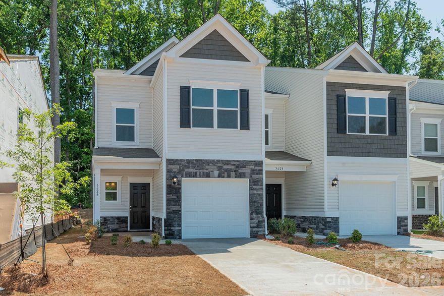 Discover the Trenton floorplan in Hickory Glen, a charming boutique community located just minutes from Uptown Charlotte. This two-story, low-maintenance end-unit townhome offers 1,287 square feet of well-planned living space, featuring 3 bedrooms and 2.5 bathrooms. The main level showcases an open-concept design with a stylish kitchen complete with 36" cabinetry, granite countertops, a spacious island, stainless steel appliances, and a pantry. The kitchen flows effortlessly into the family room, creating a comfortable and functional space ideal for both everyday living and entertaining.

Upstairs, the primary suite provides a relaxing retreat with a walk-in closet and a private bath featuring dual quartz vanities and a large shower. Two secondary bedrooms, a full bath, and a conveniently located laundry space round out the second floor. Hickory Glen offers a unique setting with just 46 duet-style homes, each designed as an end unit to maximize privacy and natural light.