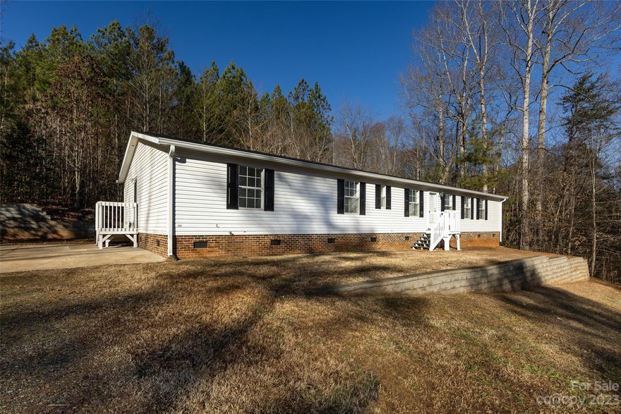 Welcome to this charming retreat in the beautiful countryside of Gaston County, NC! Nestled on over 1.6 acres of serene land, this property offers the perfect blend of tranquility & comfort. This spacious, open-concept home features 3 beds & 3 baths, 2 living areas, a separate office/study, & tall ceilings. Recently updated w/over $40K in improvements, this property boasts a fresh & modern look. The walls & cabinets in the kitchen/bathrooms have been freshly painted, complementing the new, gorgeous luxury vinyl plank flooring, new door casings, & new 3-1/4" baseboards that add a touch of elegance to the home. The property's exterior has not been overlooked with a new roof & gutters, pressure washing, tree trimming, & newly painted steps & shutters. Large primary suite includes a big walk-in closet, garden tub & shower, & dual vanity. Water heater & heat pump replaced in last 3 yrs. NOTE: home has 4 total bedrooms; however, septic permit is only for 3 bedrooms.