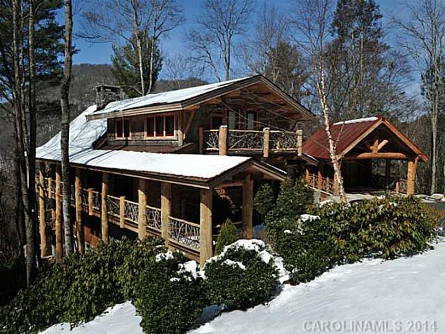 Upon entering, the craftsmenship of the tounge and groove ceiling with exposed beams is evident above the grand, floor to ceiling stone fireplace in the great room. Adjoining is the designer kitchen with a large eat-on center island and a dining area that opens to the large, wrap-around deck.