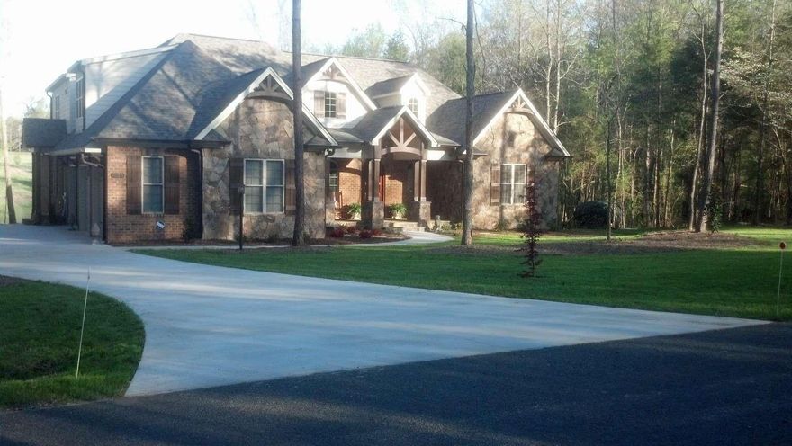 Beautiful Brick and Stone home, on the shore of a private lake - 1/4 owned lake! 1.0 approx. acre lot. Quiet secluded neighborhood with lots of woods around. Authentic custom Hardwood floors in Keeping room, Breakfast area, Dining room, Foyer, Kitchen, Great room, Master Bedroom and Upstairs Bedroom (or office). Gas cooktop in kitchen, granite counter tops and abundance of cabinets and walk in pantry. Tile floors in all baths with stone counter tops. Vaulted ceilings with exposed beams in the Keeping room and Great room. Beautiful view of the private lake. Large Master BR has tray ceiling. Tiled shower Whirlpool tub in MBA, large Walk-in closet. Upstairs large bonus room and full bath. Downstairs bedrooms, one with lake view, and a jack and jill full bathroom. Screened porch with stone floor facing the lake. Gas fireplaces in Great and Keeping room. Large fenced vegetable garden with producing Peach and Pear trees. Solar and battery backup system. Custom Irrigation system.