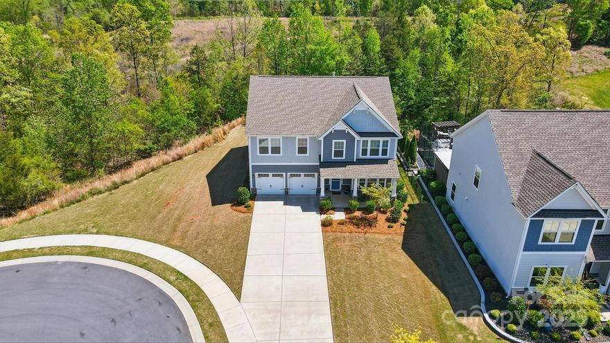 Discover living in Handsmill, a lakeside community on the shores of Lake Wylie. This pristine 2-story home sits on a quiet cul-de-sac, bordered by open space for added privacy. The open floor plan features a spacious kitchen with a stunning island w/ seating, a butler’s and walk-in pantry, main-level office/flex space, and mud room w/ a drop zone. Upstairs offers 4 bedrooms with walk-in closets, a bonus/office, & a luxurious primary suite featuring a sitting area where you can slip away for some quiet time. The primary bath has a garden tub, dual vanities, and a separate shower- you will love the enormous walk-in closet.  The covered front porch is wonderful for watching kids & pets play. The level driveway has plenty of parking for 4+ cars. Gated community amenities include a clubhouse, fitness center, outdoor pool, recreation area, walking trails, and lake access. Award-winning Clover Schools, easy commutes to shopping, dining, multiple hospitals, & Intn. Airport.