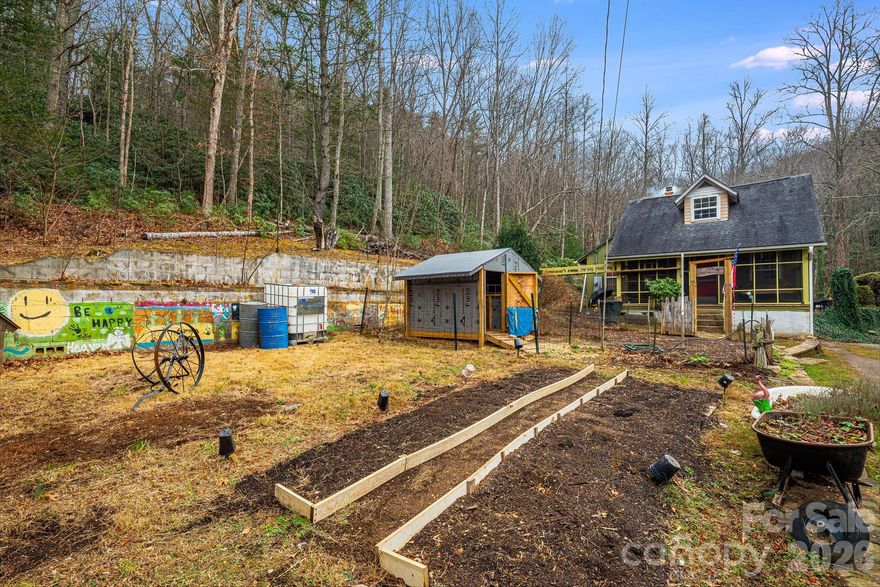 If you’ve been waiting for the perfect place to build your homesteading dream, your search ends here. Tucked into  the mountains, this property offers acreage, a charming home, a versatile tiny house (ready for your finishing touches), outbuildings, gardening space, and abundant natural water sources include a spring, creek, and pond. Multiple fenced-in areas! The home features 2 woodstoves - the main woodstove is located in the basement with access from the interior of the home. With Fairview just an 8 minute drive away and the vibrant hubs of Asheville and Black Mountain only about 20 minutes in either direction. This is a rare mix of simplicity, self-sufficiency, and convenience! The water heater is only 2 years old. The main chimney was completely rebuilt in 2022 from the basement all the way up.