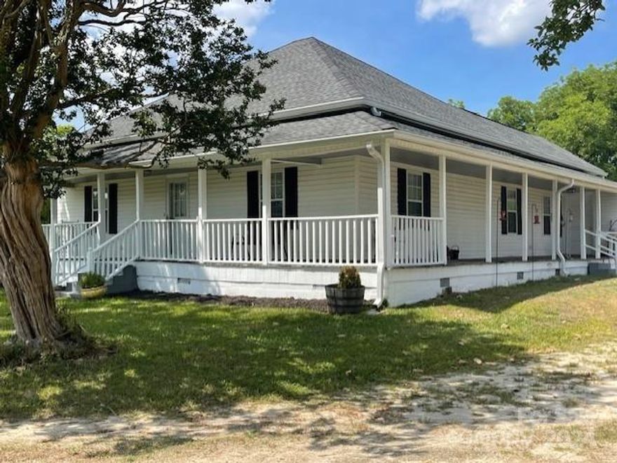 Your country farmhouse is waiting for you.   Enjoy an amazing hillside view of farmland  as you relax on your wrap around porch.  Porch is large enough to have multiple seating and conversation areas and perfect for enjoying summer breezes.  Inside has been nicely updated but kept that warm, country feel.  Every room is spacious, and can easily accommodate a growing family and large crowds.  All bedrooms are 14 X 14.  One of the front bedrooms does not have a closet, however, many houses of this age did not always have closets.  The room size is large enough to add a closet or open up one of the closets from the adjoining room.  The center hallway  (5.8 X 27.5) is perfect additional space for a sitting/reading area, home schooling, or displaying special items.  Yard features magnolia, pear, pecan, and crepe myrtle trees as well as gardening space. Outside storage building has been wired but  not  hooked up to the power. Partly insulated and has  attached shed.  Hot tub does not convey.