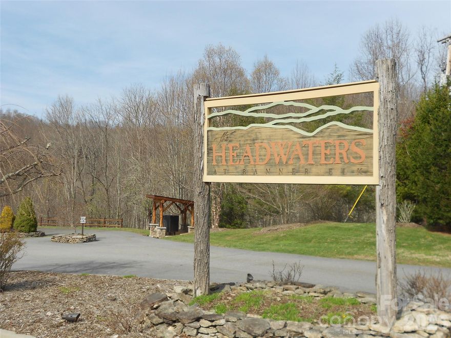 Nestled within the exclusive gated community of Headwaters near Banner Elk, this exceptional 1-acre wooded lot offers unparalleled mountain lifestyle and the community offers breathtaking long-range mountain views. This lot is a short walk to two stocked fishing lakes spanning more than 20 acres of water, perfect for fishing, kayaking, or canoeing. Located just five miles from the charming town of Banner Elk, the property combines privacy with convenient access to local dining, shopping, and year-round attractions. Residents enjoy a wealth of upscale amenities, including a stunning 6,000-square-foot, two-story clubhouse featuring a theatre room, game room, library, culinary kitchen, and elegant dining space. Outdoor recreation abounds with tennis and pickleball courts, a fitness center, dog park, basketball court, helicopter pad and miles of scenic hiking and biking trails. The community is surrounded by over 55,000 acres of protected National Park and Game Lands, enhancing both beauty and seclusion. This is a rare opportunity to build your dream mountain retreat in one of the High Country’s most sought-after communities.
