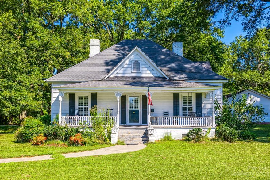 Welcome to Sweet Carolina Manor, the quintessential southern farmhouse on a beautifully wooded 3 acres in York County! You will be greeted by a welcoming rocking chair porch as you enter this updated home that still has so much character and charm as well as original hardwoods. Two living areas and multiple fireplaces to enjoy and spread out as you gather with family and friends. Dining room features an original built-in cupboard as well as a custom built corner cupboard that remains with the house. The bathrooms have been updated and the kitchen has tons of light, bright white cabinets and solid surface countertops. If one porch is not enough, check out the extra-deep back porch large enough for big outdoor gatherings and multiple areas to relax. Beautiful lot with huge oak trees. Detached carport has additional storage and property also has 2 storage barns. This former successful Airbnb can be all yours. Come discover it today!