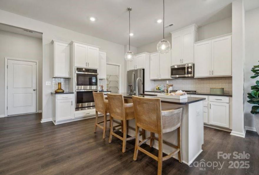 New Construction - Ready Now! Built by America's Most Trusted Homebuilder. Welcome to the Aspen at 8637 Miles Gap Road in The Ridge at Sugar Creek. Step into the foyer and discover a spacious gathering room that flows into the casual dining area and open-concept kitchen with a walk-in pantry. Upstairs, a versatile tech space and private study provide the perfect spots for work or relaxation. Two secondary bedrooms, each with walk-in closets, share a full bath. The primary suite offers a serene retreat with a private bath and generous walk-in closet. A conveniently located laundry room adds ease to everyday living in this thoughtfully designed home. Additional Highlights Include: Gourmet kitchen, study in place of loft, and large shower at primary bath. Photos are for representative purposes only. MLS#4237162