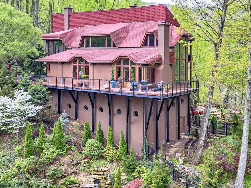 A gated mountain estate with gorgeous views and a savvy loft like vibe. Superb finishes of cherry, slate, granite, marble, custom iron work and hand wrought lighting. 1600 sq. ft. of deck wrapping a 1500 sq. ft. state of the art Snaidero kitchen and glass wrapped great room. Interior grotto and indoor lap pool, exercise room , 2 bedroom/2 bath guest/staff house, 4 car garage, workshop, barn & trails, firepit. A unique property of bespoke luxury.