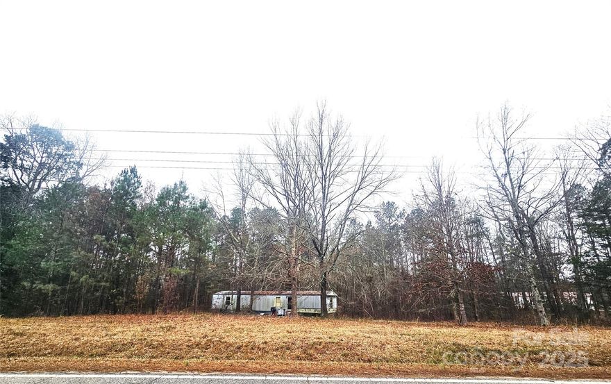 3 Acre wooded lot in the country just minutes from I-77 near Winnsboro, SC.  This lot has plenty of pines and hardwoods, partially cleared.  Beautiful country setting with a good bit of road frontage.   Land is already set up with electric pole/meter already in place, community water, septic tank.  Septic permit not available.  
Septic age is unknown, Pump needs repaired.  Actual condition of septic is not known.
Property has an old, non-livable, 1994 Fleetwood Mobile home & old storage bldg that needs to be rehabbed, removed or torn down by the new owner.  ALL you see on this land is included as is/where is/at no value/no guarantees.  DMV title to the MH will be given to the new owner at closing.  Seller will not clean off land nor remove the mobile home nor the contents inside or out.  Call for your showing appointment.  Cash or Land loans ONLY.  No owner financing & No rental due to being an Estate Sale.  Seller asking for highest & best offer no later than Monday 1/6/25 9am.