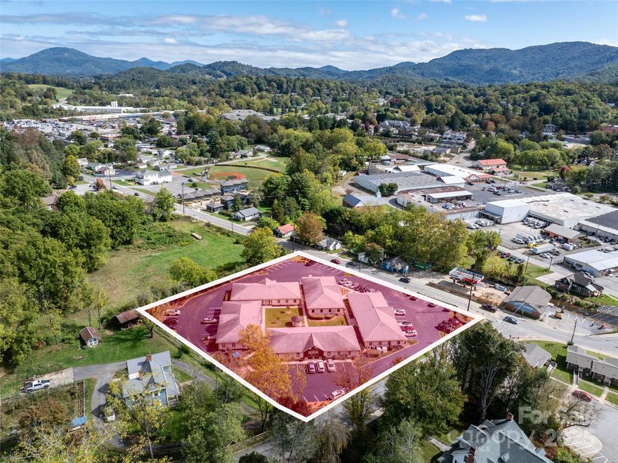 Premier Business Park in Waynesville’s Thriving Business District on prime corner lot in Waynesville’s business district, this exceptional business park offers an unparalleled investment opportunity. Just a 5-minute walk to vibrant downtown Waynesville, this fully leased property boasts 100% occupancy, ensuring immediate and consistent security for investors. Spanning a meticulously maintained complex, the park features 75 parking spaces, including designated handicap spaces, providing ample accessibility for tenants and visitors. The exterior showcases a sophisticated blend of stucco and wood, complemented by recently updated architectural shingles and high-efficiency Trane HVAC systems, earning an “A” rating for its pristine condition. City utilities, including reliable Spectrum cable, ensure seamless operations for all tenants. Unaffected by Hurricane Helene in 2024, this property stands as a resilient and low-maintenance asset in a high-demand location. Its strategic proximity to downtown Waynesville’s charming shops, restaurants, and cultural attractions and fostering a dynamic business environment. Ideal for investors seeking a turnkey commercial property with strong returns, this business park combines modern updates, robust infrastructure, and a prime location in one of Western North Carolina’s most desirable markets. Don’t miss the chance to own a top-tier commercial asset.