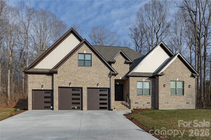Located in the Rock Barn Country Club & Spa community in Conover, this newly built home offers 4 bedrooms, 4 full bathrooms, and approximately 3,200 sq ft of open, well-designed living space. The main level features high ceilings, durable LVP flooring throughout, and a spacious open floor plan. The living room includes a modern electric fireplace and flows into the kitchen and dining areas. The kitchen includes custom cabinetry, Calacatta quartz countertops, top-of-the-line appliances, an induction cooktop with vent hood, built-in oven/microwave combo, and a large walk-in pantry. Two bedrooms are located on the main level, including the primary bedroom. Primary bath features freestanding tub, tile shower, dual vanities, and a walk-in closet. All four bedrooms in the home feature walk-in closets. Upstairs offers two bedrooms, 2 full baths, bonus space, and upgraded attic storage. Additional highlights include a dining room mini bar with beverage fridge, rooms wired for ethernet, and a 3-car garage (with a smaller bay ideal for a golf cart or sports car). Optional community amenities include golf, pool, tennis, fitness center, clubhouse, and spa access.