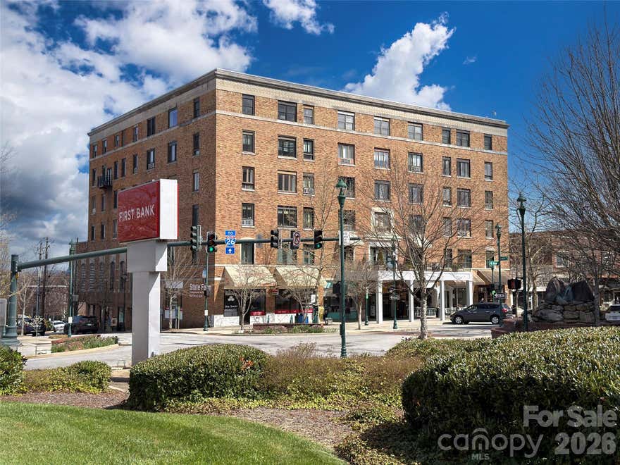 Experience the best of downtown living in the Historic Skyland Hotel! Perfectly positioned on charming Main Street, this is your opportunity to own in the heart of vibrant Hendersonville. Located just above local boutiques, restaurants, and galleries, the property also offers easy access to year-round events. These well-appointed corner units (#305–#308) blend character with convenience. Features include exposed concrete beams, ceramic tile flooring, granite countertops, and stainless steel commercial-grade appliances. Abundant natural light fills the space, highlighting beautiful views of Main Street and the surrounding mountains. The flexible floor plan is currently configured as a one-bedroom, two-bath condo. An additional efficiency unit—now used as the primary bedroom—has private hall access and could be converted into a separate studio space. This setup is ideal for guests or extended-stay rental opportunities (30-day minimum; no short-term rentals—see attached C&Rs). The Skyland Building has been thoughtfully updated in recent years, including a modernized elevator system and a new roof. Whether you’re seeking an investment opportunity or a personal retreat in one of Western North Carolina’s most desirable downtowns, this property offers an unbeatable location and a low-maintenance lifestyle. Don’t miss your chance to enjoy Main Street living at its finest.